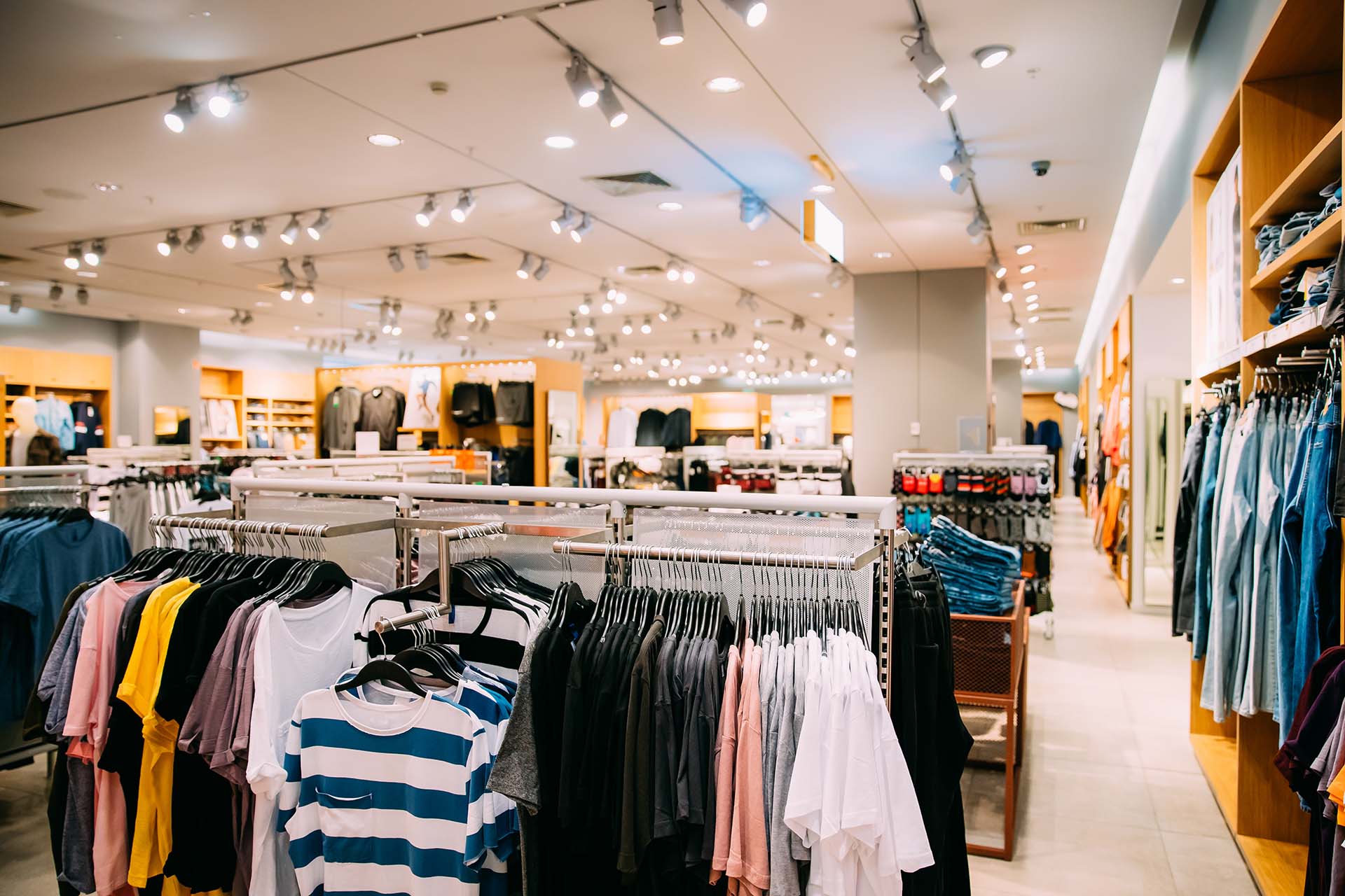 Colorful Bright Clothes On Shelves And Hanger In Store Of Shoppi